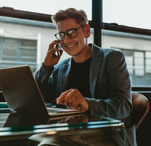 Corporate professional sitting making a phone call