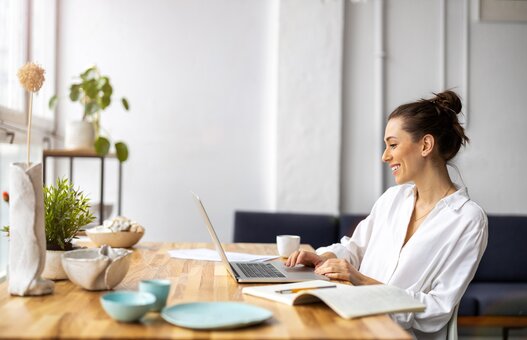 Creative young woman working on laptop in her studio