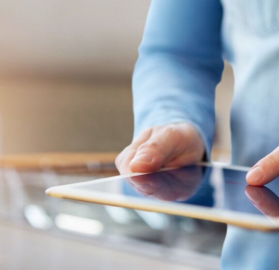 Male hand touching a digital tablet