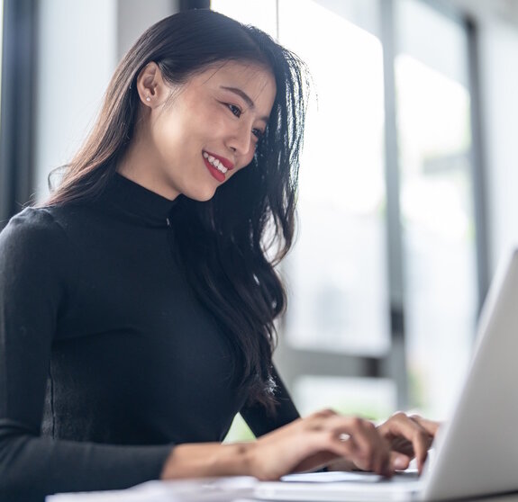 Beautiful confident asian business woman working with laptop Hands typing keyboard. Professional investor working new start up project. business planning in office. Technology business