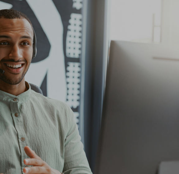 Handsome african businessman working computer while sitting in modern coworking