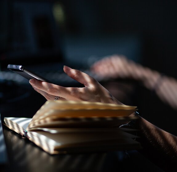 woman hands using smartphone, home office background, social media influencer