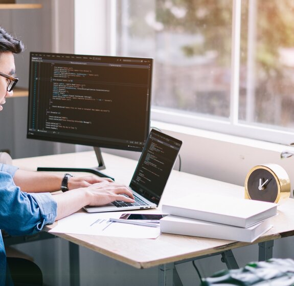 Young Asian programmer working at office