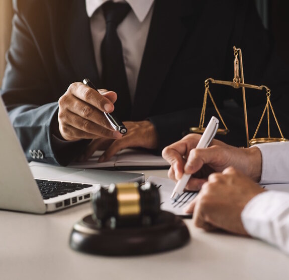 business people and lawyers discussing contract papers sitting at the table. Concepts of law, advice, legal services. in morning light