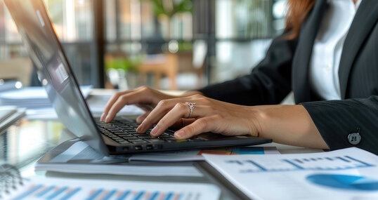 business woman close up of a person typing on a laptop computer