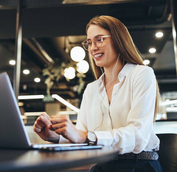 Happy young businesswoman taking a video call