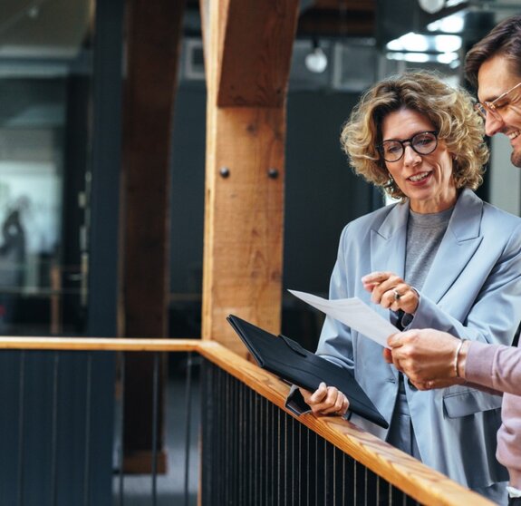 Business people analysing a financial report together. Two business people discussing in an office