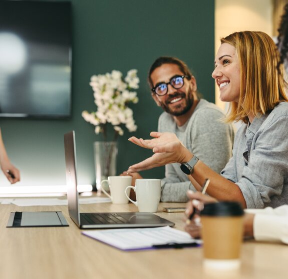 Cheerful businesswoman having a discussion with her colleagues