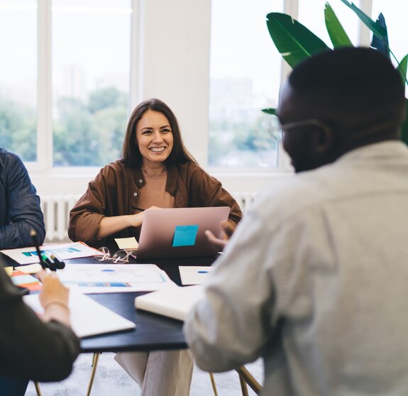 Multiracial colleagues enjoying teamwork and discussion in office