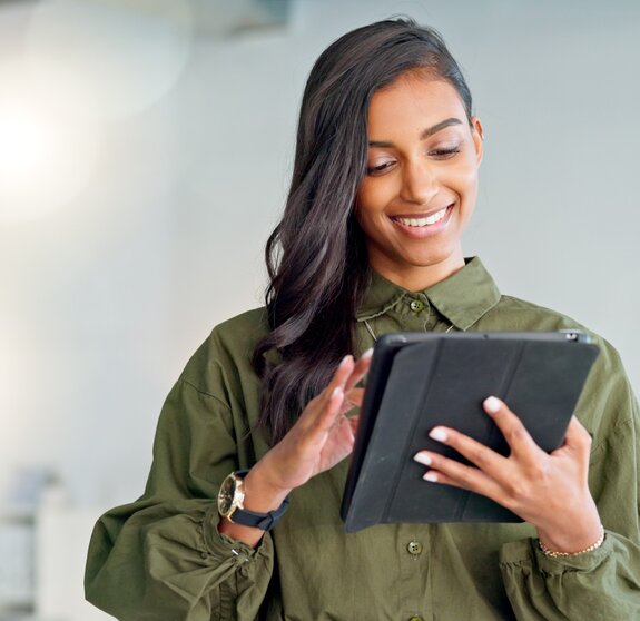 Business woman typing an email, browsing the internet and searching for ideas on a tablet at work. Female corporate professional, expert and designer scrolling on social media or reading a blog