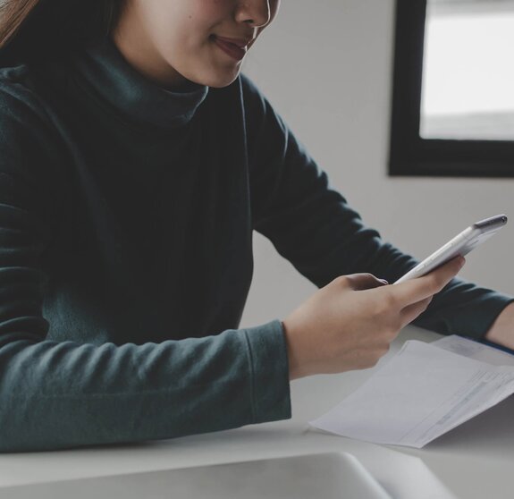 panoramic banner. young woman using mobile smart phone for scan and payment online with family budget cost bills on desk in home office, plan money cost saving, investment, finance, expenses concept