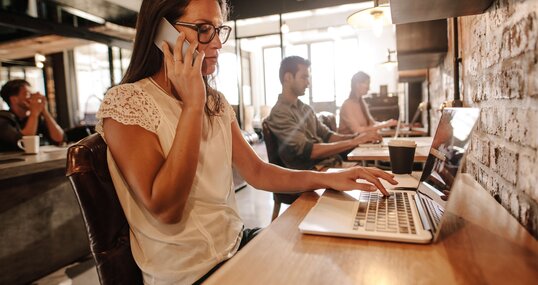 Eine Frau nimmt über Microsoft Teams per Mobiltelefon an einer Onlinebesprechung teil.