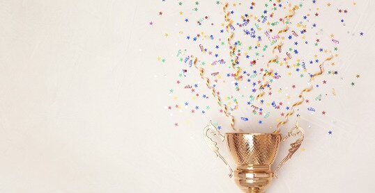 Trophy and confetti on light background, top view with space for text. Victory concept