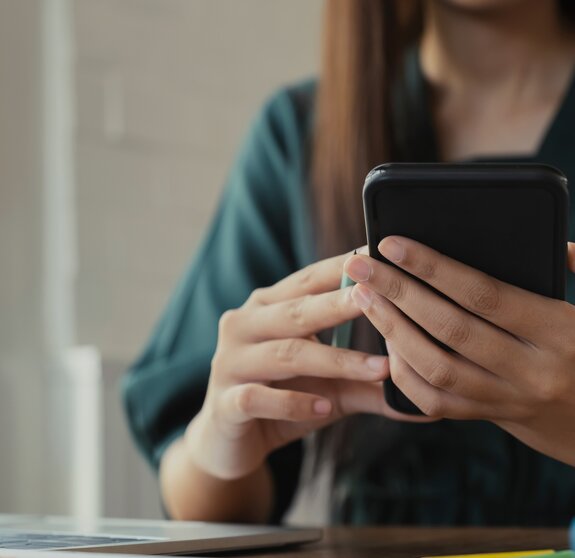 Close up of woman using mobile phone.