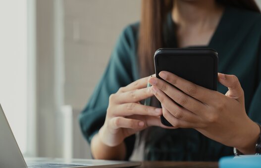 Close up of woman using mobile phone.