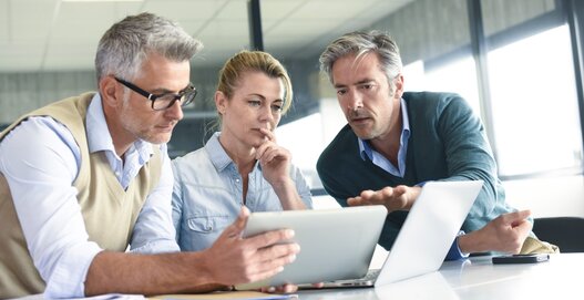 Business people in a meeting using tablet